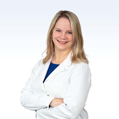 hearing care specialist in a white coat with arms crossed
