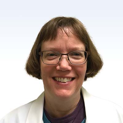 Cynthia Bjur, hearing care specialist at [insert company name], wearing a white coat against a light blue background.