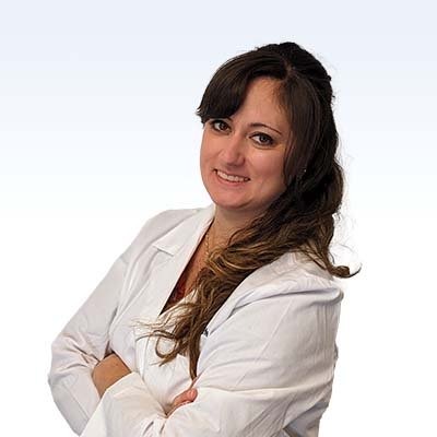 Hearing care professional wearing a white coat with arms crossed