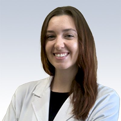 hearing care specialist in a white coat with long brown hair