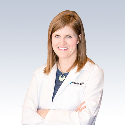 Erin Davlin-Jend wearing a HearingLife white coat.