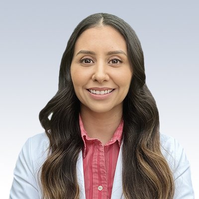Professional woman with long wavy brunette hair wearing a white lab coat and red collared shirt.