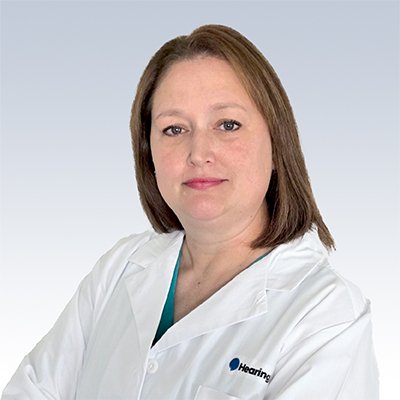 Hearing care specialist wearing a white lab coat with the HearingLife logo.