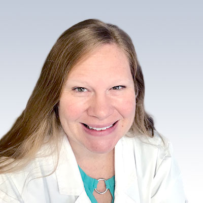 Jennifer Bickley, hearing care professional, wearing a white lab coat against a neutral background.