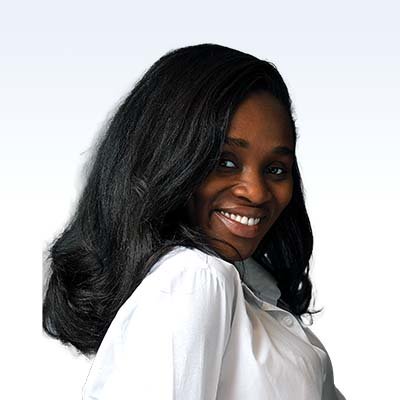 Jennifer Boakye, hearing care professional with long black hair wearing a white button-up shirt.