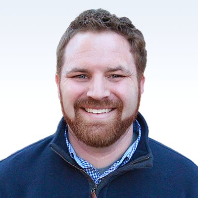 Justin Nations, hearing care professional wearing a navy jacket over a checkered shirt