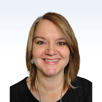 Kimmy Widell, hearing care specialist with shoulder-length blonde hair wearing a black top.