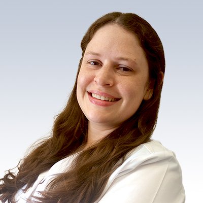 Lauren LeClercq, hearing care professional with long brown hair wearing a white coat against a light gradient background.