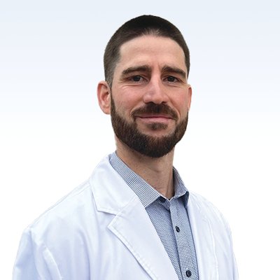 hearing care professional wearing a white coat with a collared shirt