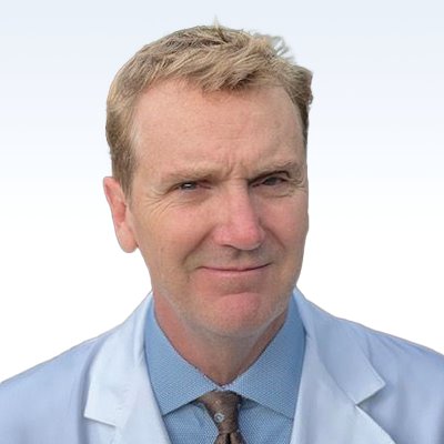 michael kinney hearing care professional in a white coat