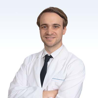 hearing specialist in a white coat with arms crossed