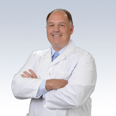 hearing care professional in a white coat with arms crossed