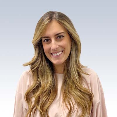 nicole sefershayan, hearing care professional with long blonde highlighted hair wearing a light pink blouse