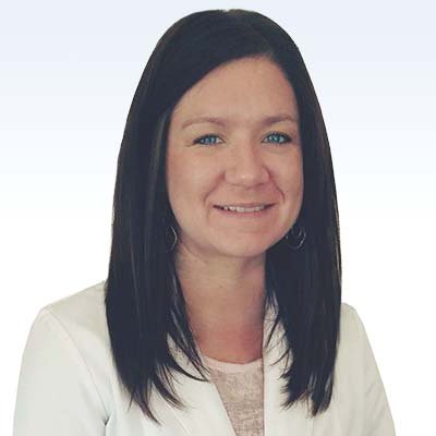 patricia landvatter, hearing care specialist wearing a white coat with straight dark hair