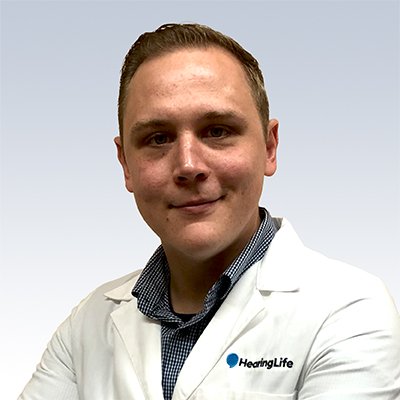 Paul Wampler, hearing care professional at HearingLife wearing a white coat.