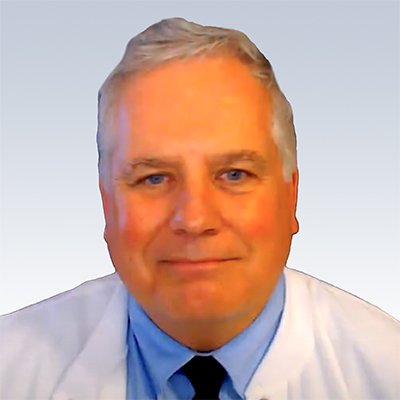 Rick Abromeit, hearing care professional wearing a white coat and blue shirt with a tie.