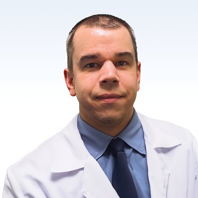 hearing care professional wearing a lab coat and tie