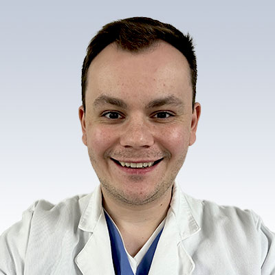 Simon Bobrovskii, hearing care professional in a white coat.