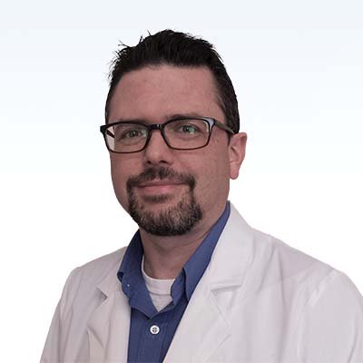 theodore bunn, hearing care professional wearing a white coat