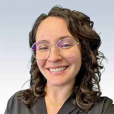 valerie mull, hearing care specialist with curly dark hair wearing a black top