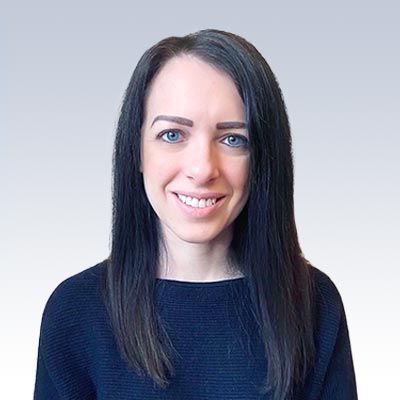 Dr. Vanessa Forbes, hearing care professional, with long dark hair and a neutral background.