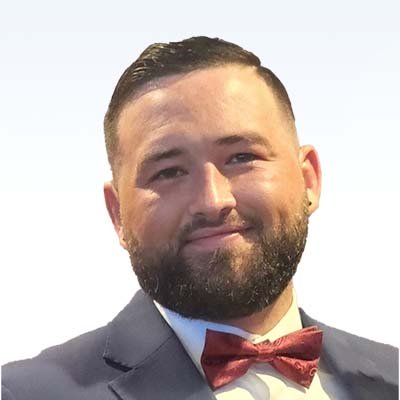 zachary barton, hearing care specialist in formal attire wearing a red bow tie