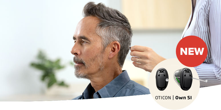 Man being fitted with Oticon Own SI™ hearing aid