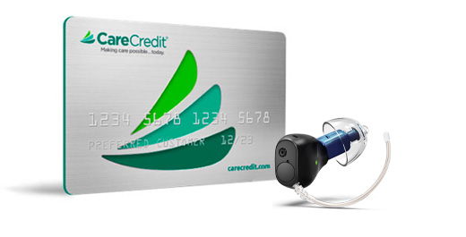 CareCredit card alongside modern hearing aid device