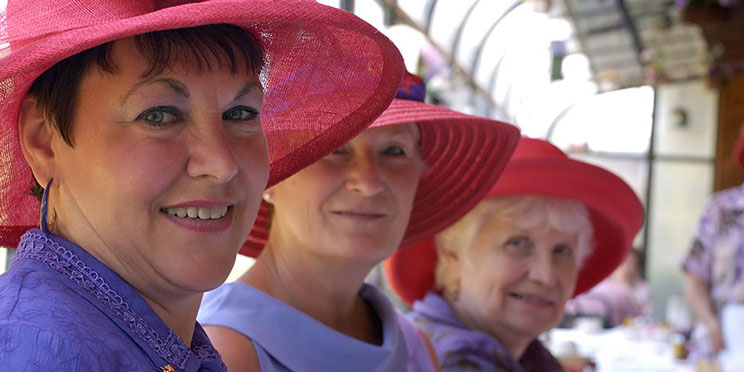 Image show 3 women with red hats