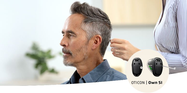 Man being fitted with Oticon Own SI™ hearing aid