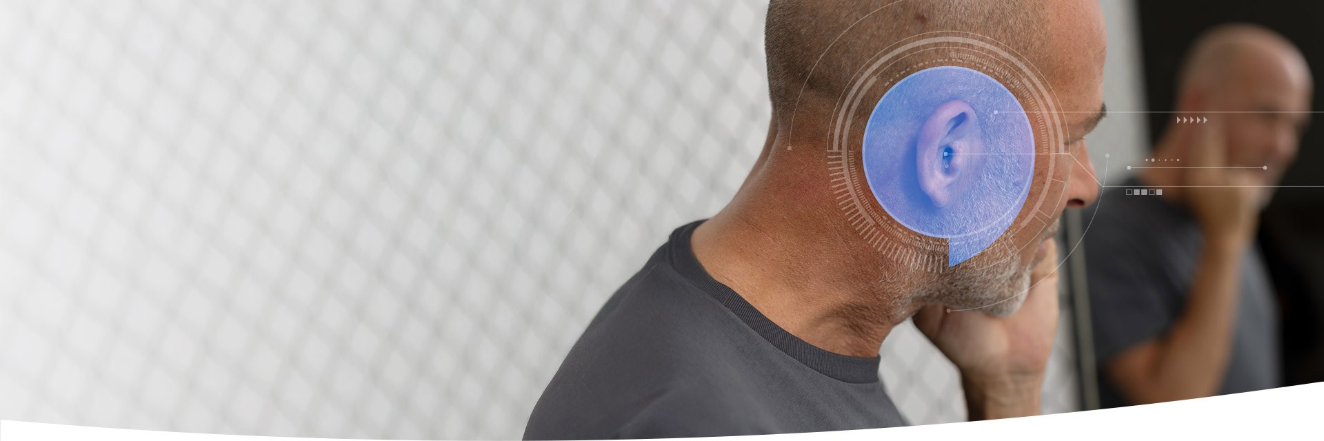 Man using hearing aid with futuristic technology visual overlay.