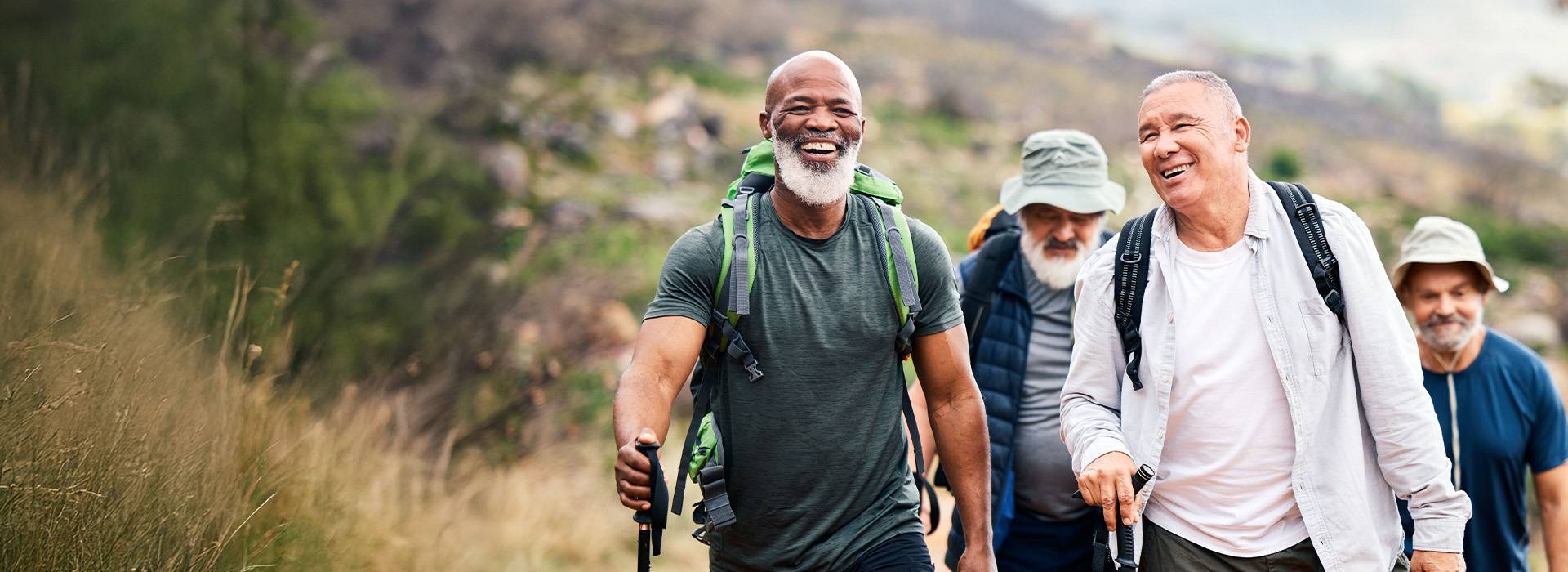 Group of friends enjoying a hike with one man wearing hearing aids.