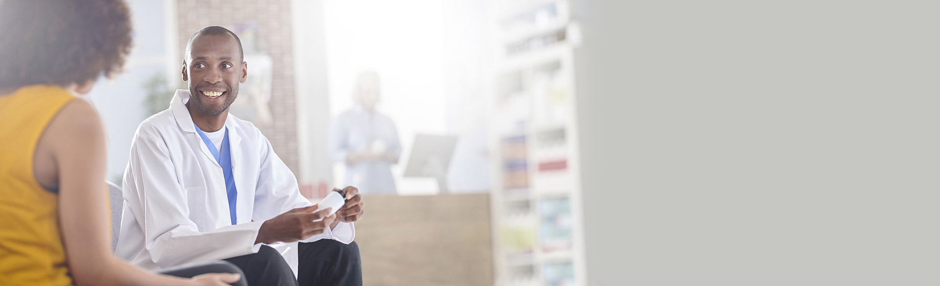 Image show an audiologist smiling to a customer in a hearing center near you