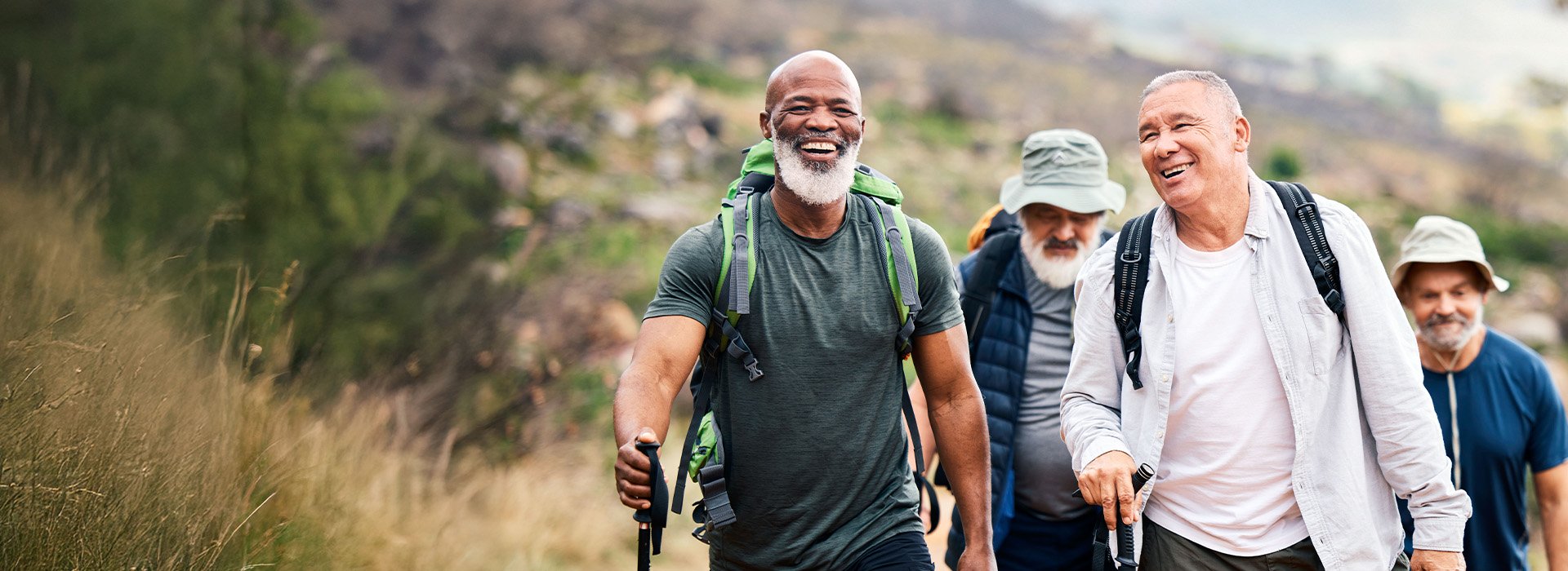 Group of friends hiking and smiling - man wearing hearing aids