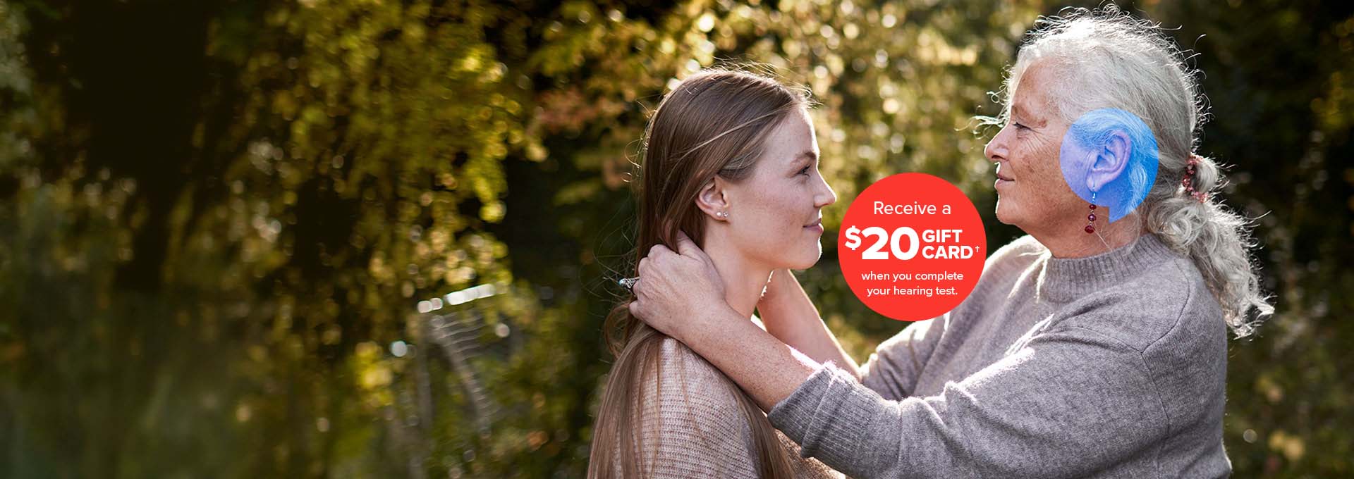 Grandmother with granddaughter hugging - Receive a $20 gift card† when you complete your hearing test. 