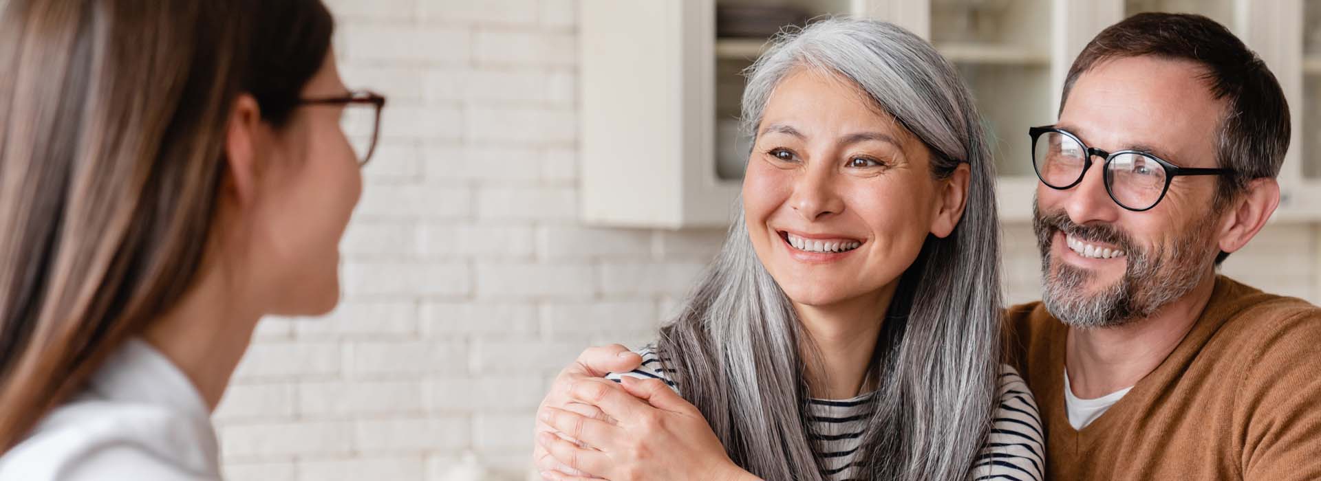 Couple discussing health insurance options with a professional