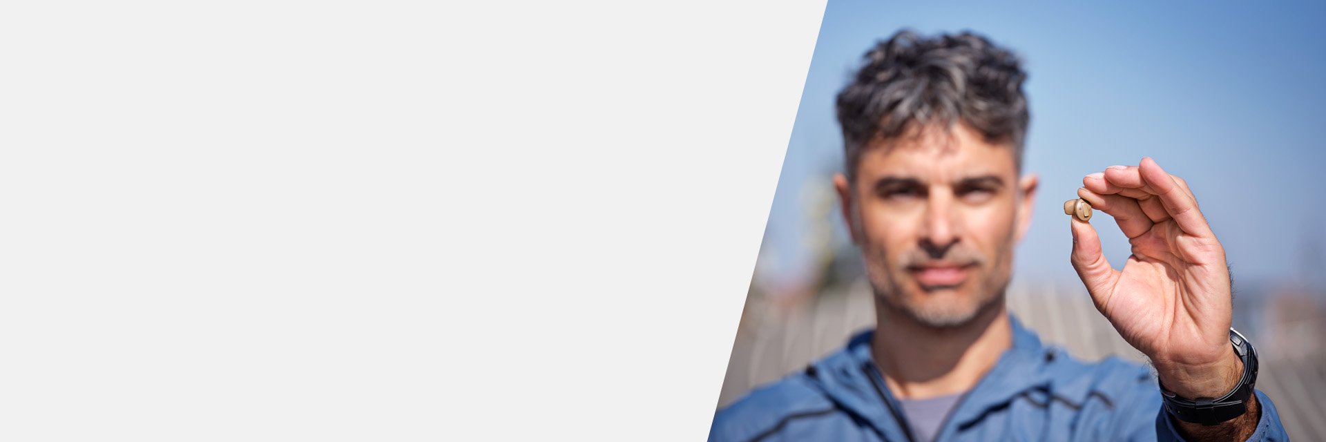 man displaying Oticon Own hearing aid