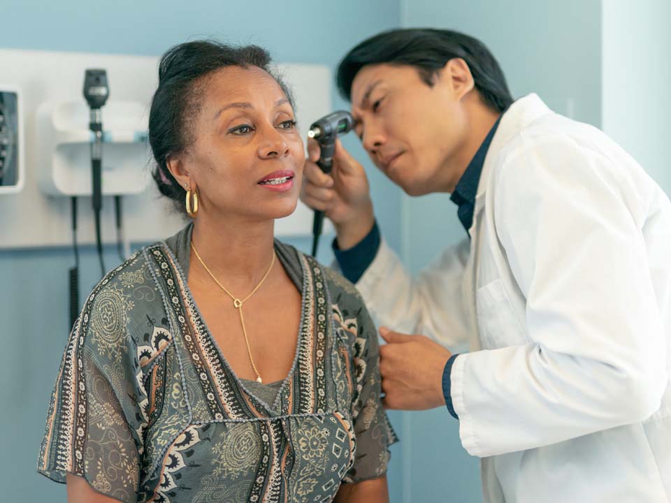 Image shows woman during hearing test