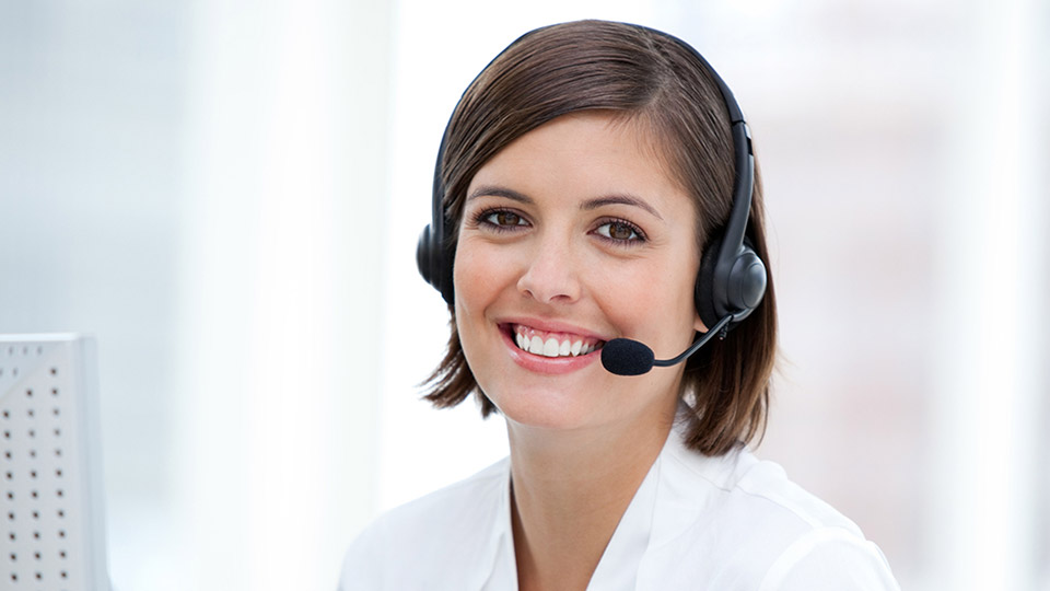 Call center representative providing customer support while wearing a headset.