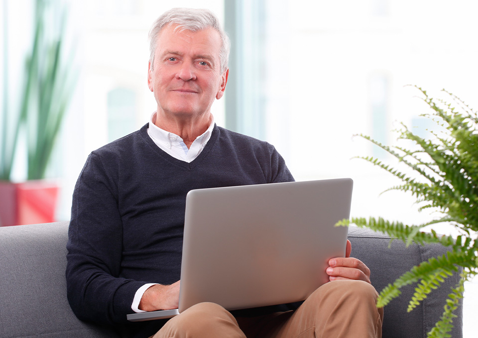 Man  smiling with laptop