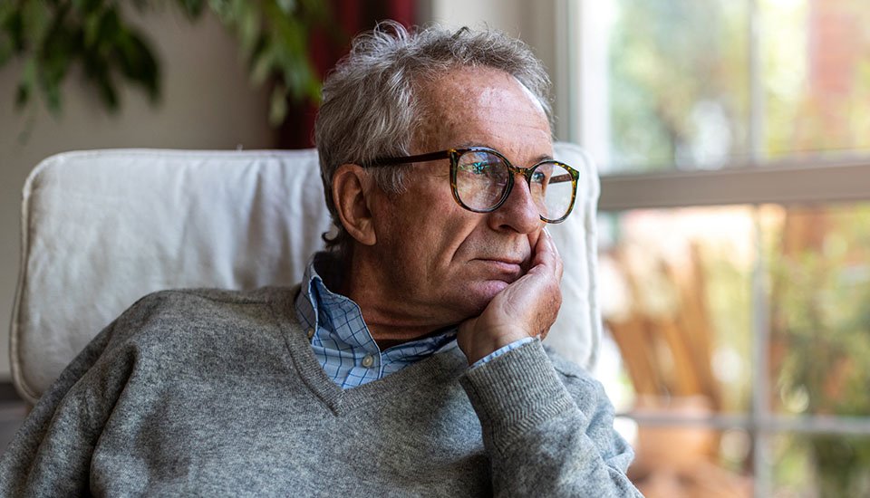 melancholy man staring out of window