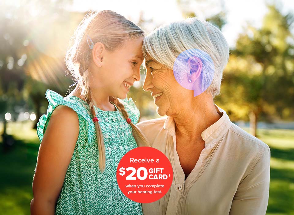 Grandmother with granddaughter hugging - Receive a $20 gift card† when you complete your hearing test. 