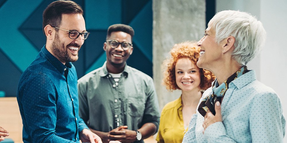 Team members collaborating and shaking hands during a professional meeting