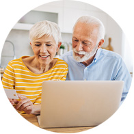 mature couple looking at laptop and finances