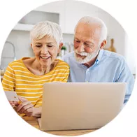 mature couple looking at laptop and finances
