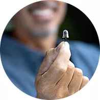 Person holding a hearing aid