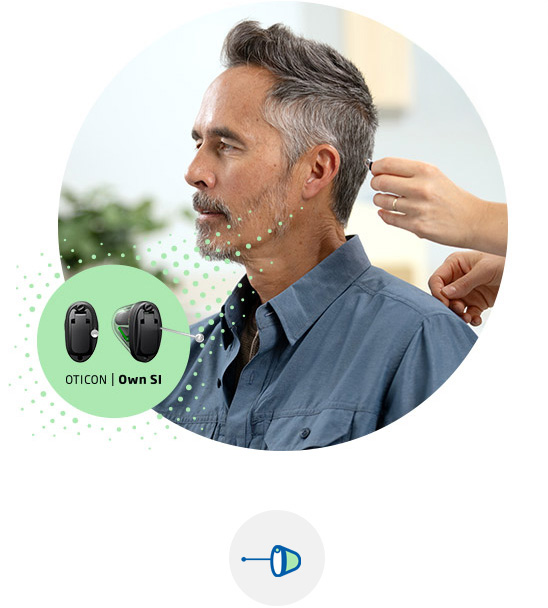 Man being fitted with the Oticon Own SI™ hearing aid.