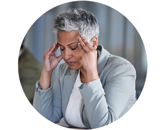 Person experiencing stress and discomfort from tinnitus while holding her head.