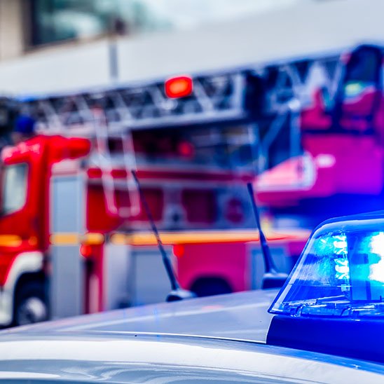 Emergency vehicles with flashing lights and sirens