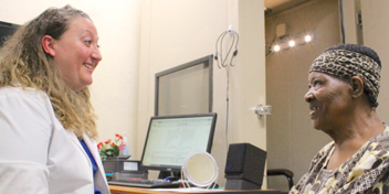 Hearing care specialist providing personalized consultation to a patient in a clinic.